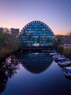 Aerial view of BBCC Berliner Bogen Conference Center at blue hour with Bille flood basin in the