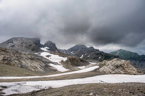 Bare rocky mountain landscape with remnants of snow in bad weather, Rote Härd, Bernese Alps,