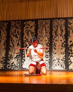 Young Thai man in traditional clothing in a historic show with knives and swords, Old Chiang Mai