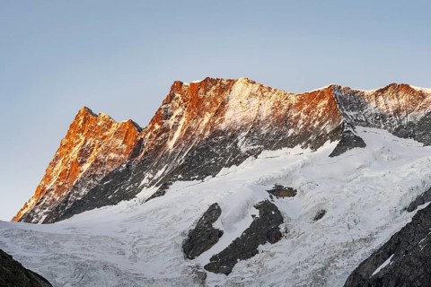 Impressive high-alpine landscape, Finsteraarhorn and Agassizhorn mountain peaks with alpine glow at