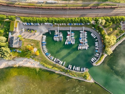 Aerial view, top down view of the marina, boat harbor with lined up boats on the lakeside of