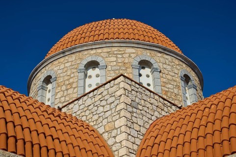 Agiou Sarvas monastery, Agion Pandon church, close-up of a church with orange stone dome and blue