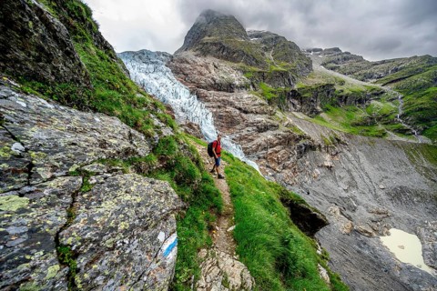 Mountaineers on a hiking trail, dramatic mountain landscape with Lower Arctic Sea glacier, Bernese