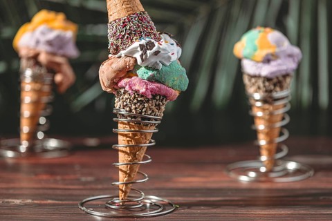 Ice cream cones with colorful ice cream, decorated with sprinkles