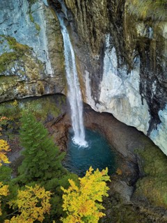 Aerial view of Berglistüber waterfall in autumn-colored surroundings, Linthal, Klausenpass, Canton