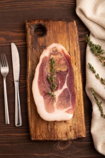Dry-aged steak, Pork ham with thyme on brown wooden background and linen textile. top view, flat