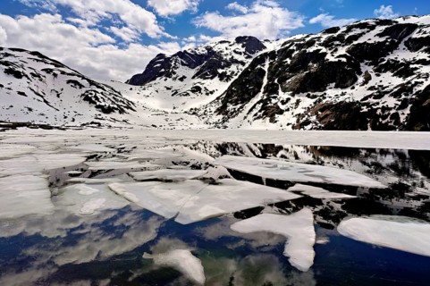 Ice floes float in the half-frozen Upper Murgsee, Murgtal, Canton of St. Gallen, Switzerland