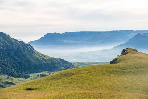 Green fields and mountains, cathedral range mountainous landscape, Drakensberg Mountains,
