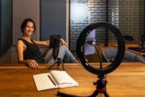 Relaxed content creator resting after recording session in modern studio