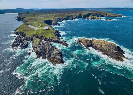 Aerial drone photo of Iighthouse on the rocky cliffs and heavy atlantic ocean surf, Strathy point,