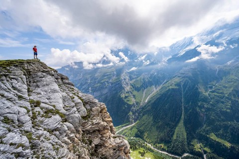 Mountaineers in front of picturesque mountain scenery at the summit of Tanzbödeli, Bernese Alps,