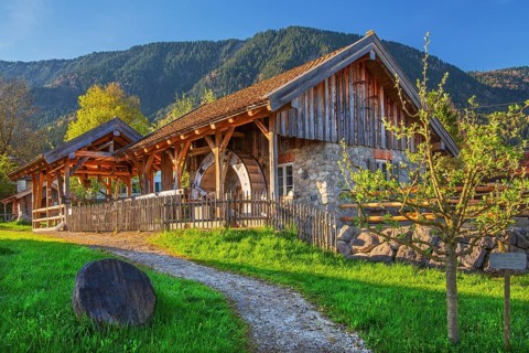 Historic Schleifmühle, water mill, in the village in spring, Ohlstadt, Loisach Valley, The Blue