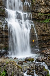 Adventure, Little hiker under large Cascata di Mezzo waterfall, long exposure, Vallesinella,