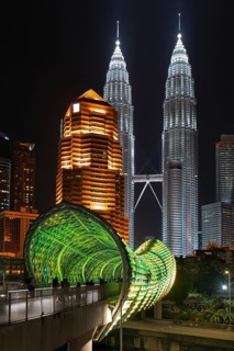 Saloma Link, Petronas Towers, KLCC Twin Towers and skyscrapers illuminated at night in capital city