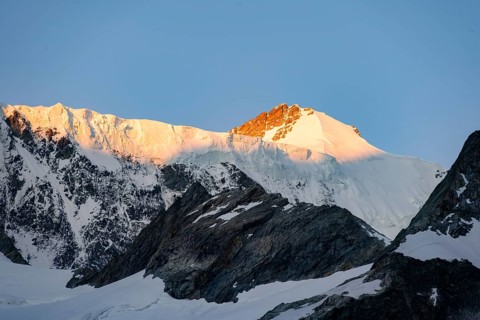 Impressive high-alpine landscape, Großes Fiescherhorn mountain summit with alpine glow at sunrise,