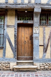 Old wooden door on a half-timbered house in the old town of Troyes, Aube department, Grand Est