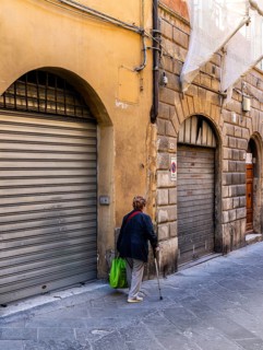 Senior woman with walking stick, Siena, Tuscany, Italy