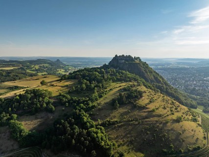 Aerial view of the Hohentwiel volcanic cone with Germany's largest fortress ruin, in the morning