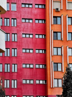 Fragments of modern urban architecture. The red and orange walls of high-rise buildings, Minsk,