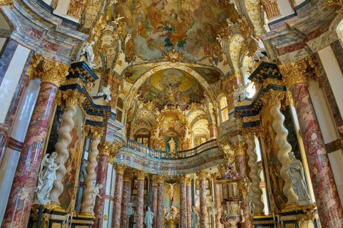 Magnificent baroque hall with gilded decorations and ornate frescoes on the ceiling, Hofkirche,