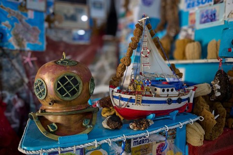 Diving helmet and model boat on a blue exhibition with sponges and maritime themes, Sponge