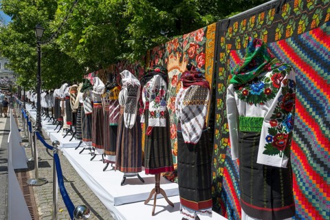 Exhibition of traditional clothing with colorful outdoor tapestries, folklore festival, Chisinau,