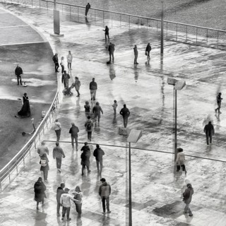 View of a crowd of people with window reflection and movement