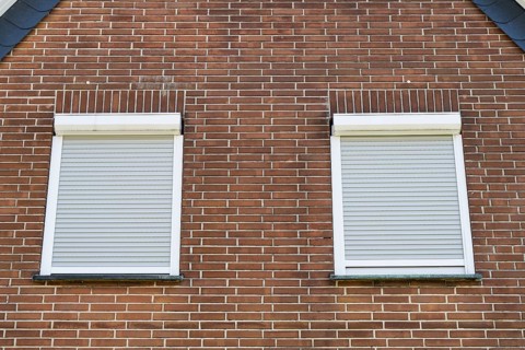 Window with closed shutters in a brick façade, detail, Westphalia, North Rhine-Westphalia, Germany