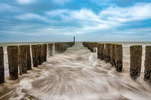 Coastal protection, through wooden posts, paalhoofden, on the beach, breakwater, the piles, some of