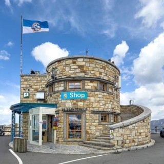 Round observation tower on 2571 meters high Edelweiss peak with flagpole and flag with