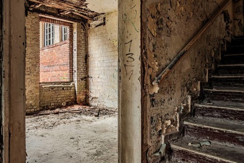 Empty dilapidated room and climb to the attic, former pulmonary hospital and lost place Heilstätte