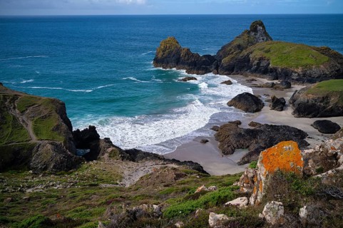 Rocks with lichens against coastal landscape, coast, rock formations, rocks, sandy beach, beach,