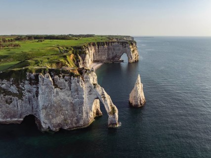 Aerial view of the Porte d'Aval rock formation in the evening sun, well-known sights on the chalk