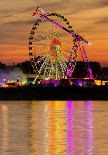 Rheinkirmes, largest funfair on the Rhine in a colorful sunset with a view over the river,