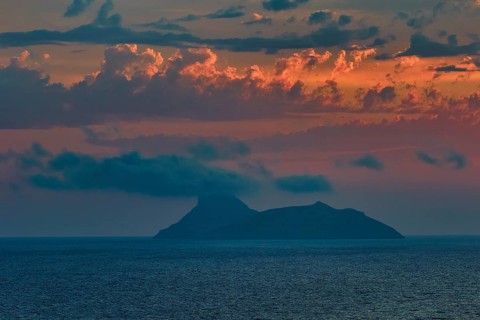 Paximadia island, colorful sunset over an island in the sea with dramatic cloud landscape, Matala,
