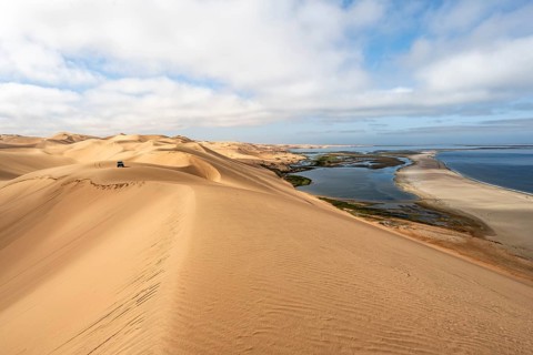 Sand dunes and sea in morning light, Atlantic coast and Namib desert, impressive desert landscape,