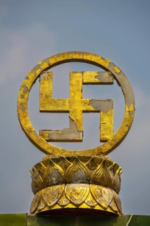 Golden swastika symbol in traditional Buddhist form, symbol of luck, protection and the cosmic