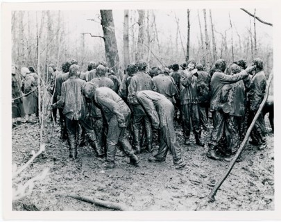 Men in muddy, fun, ritual, group of people is visible in a muddy forest area, state of chaos