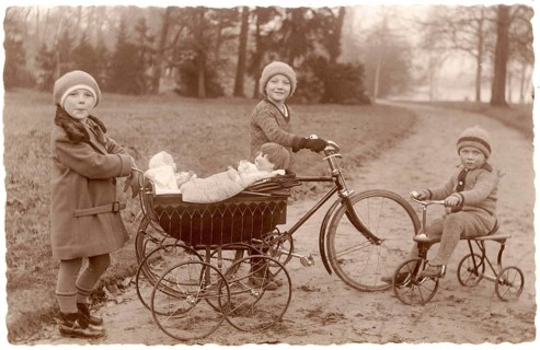 Girls in the park, tricycle, doll pram, twenties, children with bicycle and stroller in the park, a