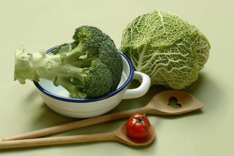 Savoy cabbage and broccoli with cooking spoon