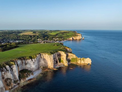 Aerial view of the Porte d'Amont rock formation, Falaise d'Amont shortly after sunrise, a landmark