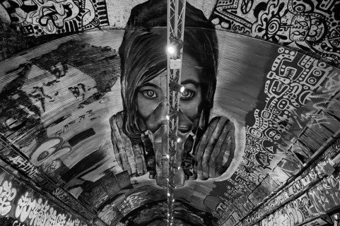 Portrait of a woman standing on the ceiling, legal, temporary graffiti in the graffiti tunnel,