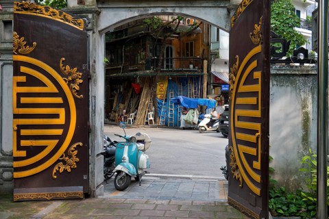 A view from a historic temple courtyard of handcrafted bamboo ladders, metre-long bamboo poles,