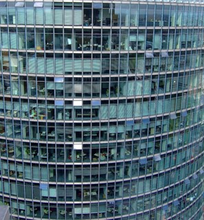 Tall office building complex with many windows that provide insights into various offices, Berlin,