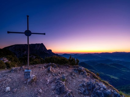 Dawn at the summit cross of Rauhen Kopf, behind the Untersberg, Berchtesgaden Alps, Bischofswiesen,