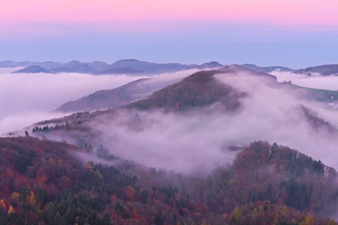 View from the Gisliflue of the Jurassic foothills covered in fog with the water fluh in the light