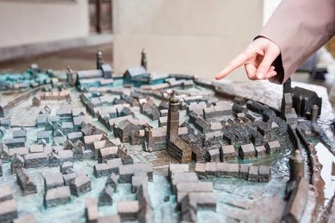 Close-up of a city model with hand pointing at buildings, Isny, Allgäu, Bavaria, Germany