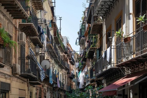 Closely lined balconies of an old town street with clotheslines, Palermo, Sicily, Italy
