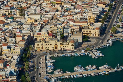 Urban landscape with harbor, boats and Mediterranean architecture, Pothia, main town, port,