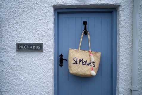 Bag with St Mawes lettering hanging on front door, St Mawes, Cornwall, England, Great Britain,